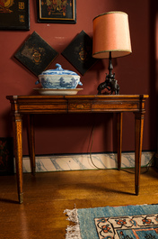 An inlaid wooden Empire-style table with brass mounts on the legs, probably France, 19th C.