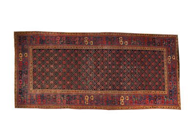 An Oriental rug with geometric motifs and floral design, wool on cotton, 20th C.