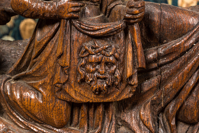 A Flemish carved oak retable fragment depicting the 'Road to Calvary with Saint Veronica', 16th C.