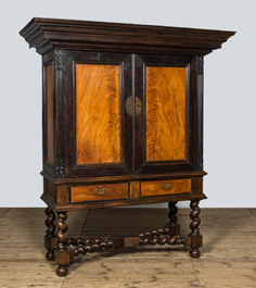 A mahogany and partly ebonised wooden two-door cupboard on foot, 19th C.