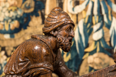 A Flemish carved oak retable fragment depicting the 'Road to Calvary with Saint Veronica', 16th C.