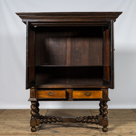 A mahogany and partly ebonised wooden two-door cupboard on foot, 19th C.