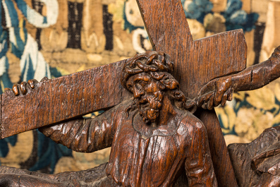 A Flemish carved oak retable fragment depicting the 'Road to Calvary with Saint Veronica', 16th C.