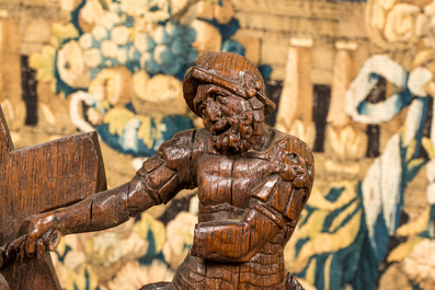 A Flemish carved oak retable fragment depicting the 'Road to Calvary with Saint Veronica', 16th C.