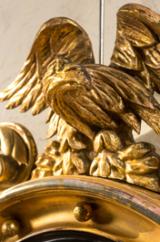 A gilt wooden eagle-topped butler mirror with ebonised border, ca. 1900