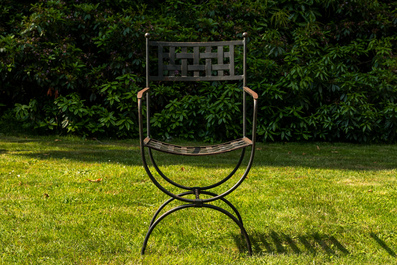 A wrought iron table with slate and wooden top with six chairs, 20th C.