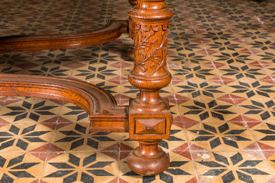 A large oval wooden table on carved baluster-shaped legs, early 20th C.