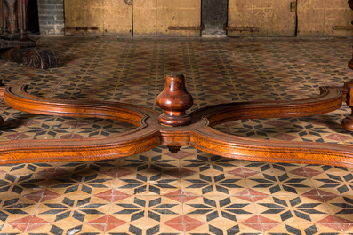 A large oval wooden table on carved baluster-shaped legs, early 20th C.