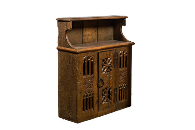 An English Gothic carved oak hanging cupboard composed of old elements, 17th C. and later