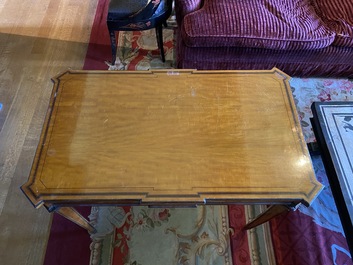 An inlaid wooden Empire-style table with brass mounts on the legs, probably France, 19th C.