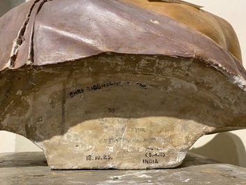 A polychrome plaster bust of an Indian wearing a turban, illegibly signed, dated 1925