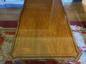 An inlaid wooden Empire-style table with brass mounts on the legs, probably France, 19th C.