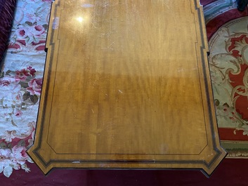 An inlaid wooden Empire-style table with brass mounts on the legs, probably France, 19th C.