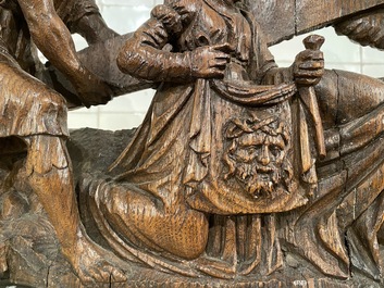 A Flemish carved oak retable fragment depicting the 'Road to Calvary with Saint Veronica', 16th C.