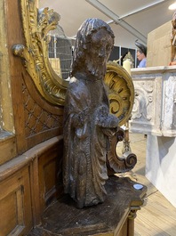 A Spanish walnut figure of John the Baptist, mid 15th C.