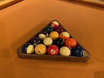 A burl wood veneered billiard table with accompanying lighting and cue holder, 20th C.