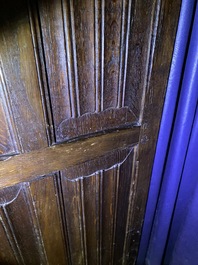 A Flemish oak three-door cupboard with carved panels, 16th C.