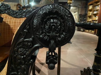 An Anglo-Indian colonial carved wooden sofa with two matching chairs, late 19th C.