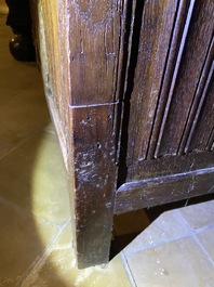 A Flemish oak three-door cupboard with carved panels, 16th C.