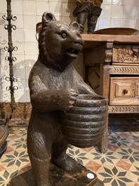 A 'Black Forest' wooden bear holding a beehive, Switzerland, 19th C.