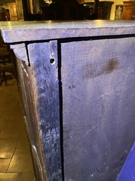 A Flemish oak three-door cupboard with carved panels, 16th C.