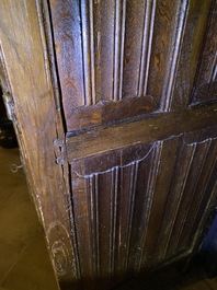 A Flemish oak three-door cupboard with carved panels, 16th C.