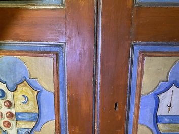 A pair of large Italian polychrome wooden two-door cupboards with coats of arms, 17th C.