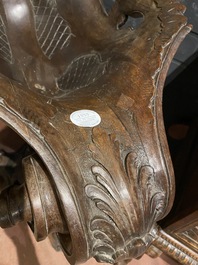 A richly carved walnut jardini&egrave;re or stand with angels, 19th C.