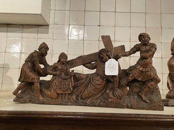 A Flemish carved oak retable fragment depicting the 'Road to Calvary with Saint Veronica', 16th C.