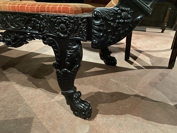 An Anglo-Indian colonial carved wooden sofa with two matching chairs, late 19th C.