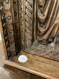 A carved oak panel depicting Saint James with a bishop, The Low Countries, late 15th C.