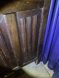 A Flemish oak three-door cupboard with carved panels, 16th C.