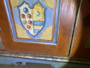 A pair of large Italian polychrome wooden two-door cupboards with coats of arms, 17th C.