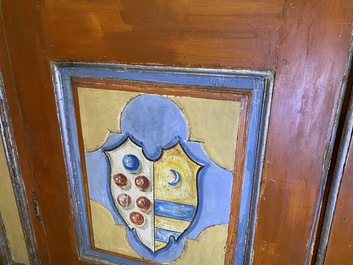 A pair of large Italian polychrome wooden two-door cupboards with coats of arms, 17th C.