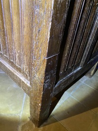 A Flemish oak three-door cupboard with carved panels, 16th C.