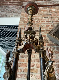 A pair of large polychromed and gilt processional torches with cherub heads, 18th C.