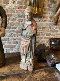 A Flemish carved and polychromed oak figure of a bishop on an armorial base, ca. 1500