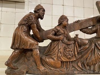 A Flemish carved oak retable fragment depicting the 'Road to Calvary with Saint Veronica', 16th C.