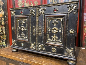 An ebonised and inlaid wooden cabinet, 19th C.