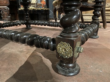 A partly ebonised walnut table on barley-twist base with baluster legs, 19th C.