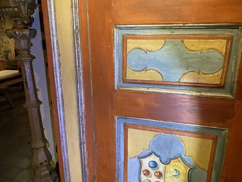 A pair of large Italian polychrome wooden two-door cupboards with coats of arms, 17th C.