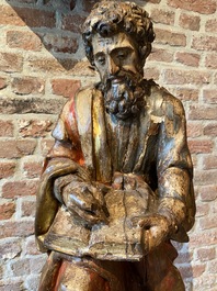 A Spanish polychromed walnut sculpture of Saint Luke, 16th C.
