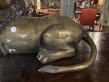 A patinated bronze reclining lion, 20th C.