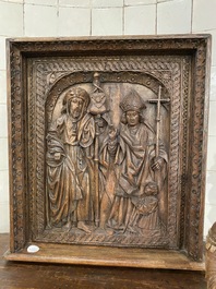 A carved oak panel depicting Saint James with a bishop, The Low Countries, late 15th C.