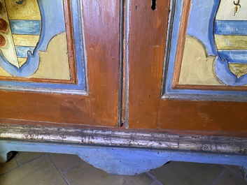 A pair of large Italian polychrome wooden two-door cupboards with coats of arms, 17th C.