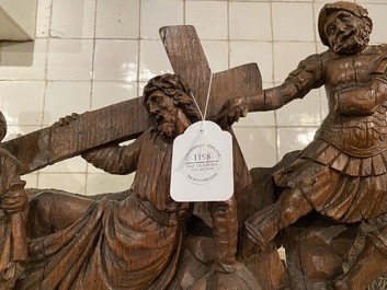 A Flemish carved oak retable fragment depicting the 'Road to Calvary with Saint Veronica', 16th C.