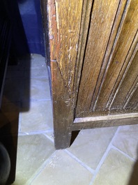 A Flemish oak three-door cupboard with carved panels, 16th C.