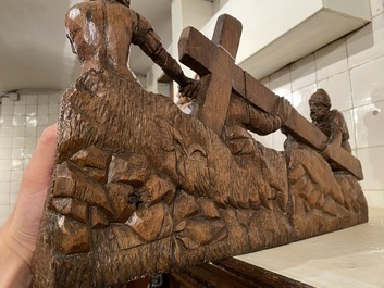 A Flemish carved oak retable fragment depicting the 'Road to Calvary with Saint Veronica', 16th C.