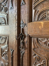 A rare large Flemish oak four-door cupboard with carved X-panels and wrought iron mounts, 1st half 16th C.