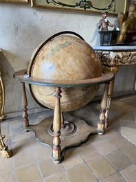 A celestial globe on a polychrome wooden base, 19th C.